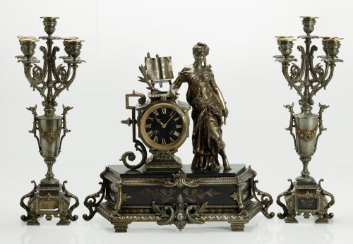 Clock garnish and pair of candlesticks, in gilded metal and