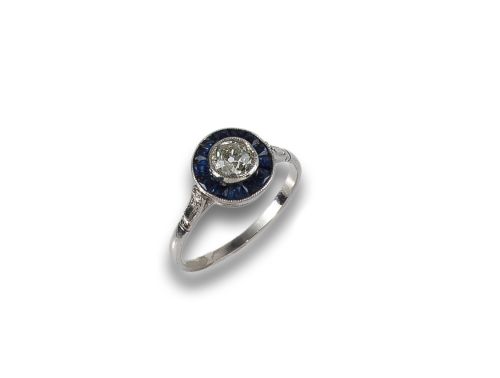 HALO RING IN PLATINUM, SAPPHIRES AND DIAMONDS