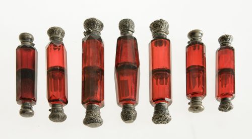 Collection of seven garnet crystal perfume bottles, 19th ce